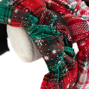 Knotted Christmas headband with red and green plaid fabric and white snowflake patterns