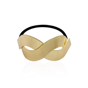 Elastic hair tie with a brushed golden infinity symbol on a clean white background