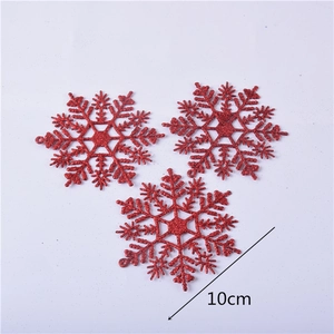 Three 10cm red glitter snowflake ornaments for Christmas tree decoration displayed on gray