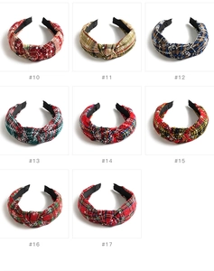 Detail showing eight plaid Christmas headbands with festive snowflakes and knot design