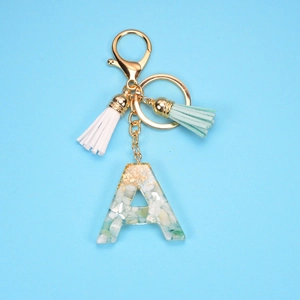Resin letter A keychain with gold foil, white shell fragments and dual leather tassels