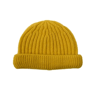 Detail of mustard yellow ribbed knit beanie for kids showing thick textured wool fabric