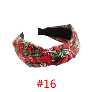 Detail of red plaid Christmas headband with white snowflake patterns and twist knot design