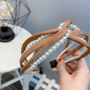 Detail of vintage brown satin headband with layered faux pearl wrap and knot design