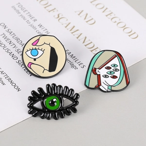Artistic Picasso style enamel pins featuring surreal multi-eyed girl designs for backpacks