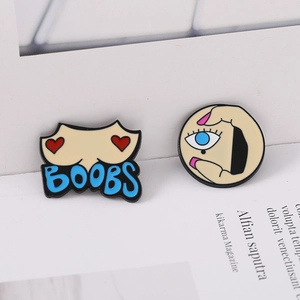 Artistic Picasso style enamel pins featuring creative breast design and hand holding an eye