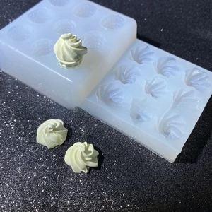 Detailed view of 9-cavity silicone mold for 3D spiral cream and ice cream cone shapes