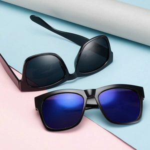 Retro oversized sunglasses for men and women featuring black frames with blue coated lenses