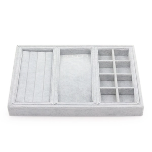Light gray velvet jewelry organizer tray with compartments for rings and necklaces