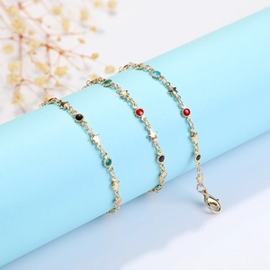 Golden bracelet with colorful star-shaped enamel charms and round lobster clasp