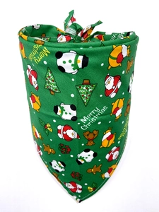 Detail of green cotton dog bandana with Merry Christmas print and holiday patterns