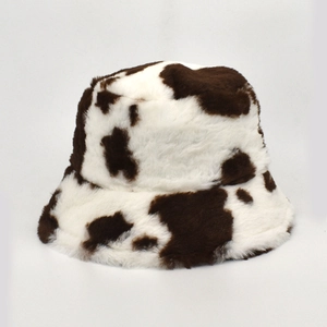 Detailed view of plush faux fur texture on this cow print winter bucket hat
