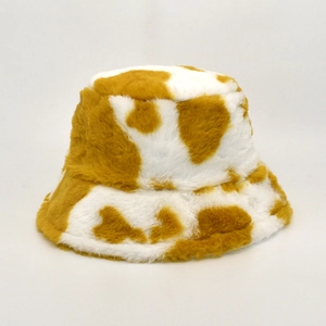 Detailed close-up of soft cow print faux fur texture in ginger yellow and white color