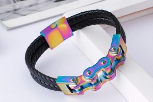 Detail of double-strand black braided leather bracelet with rainbow bicycle chain metal link