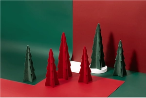 Detail of flocked ceramic Christmas trees in various sizes on red and green backgrounds