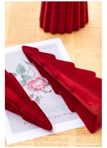 Close-up of red flocked Christmas tree decor showing matte velvet texture and soft detail