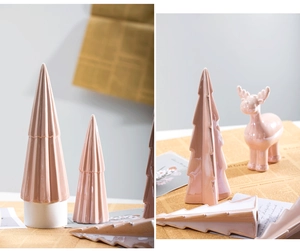 Detail of pink ceramic Christmas tree and elk set with glossy finish for home decor