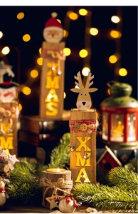 Macro detail of wooden Christmas Santa and reindeer light with warm glowing Xmas letters
