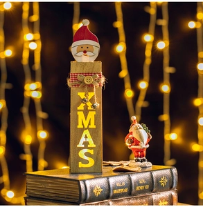 Detail of wooden XMAS light box with Santa Claus figurine on vintage books