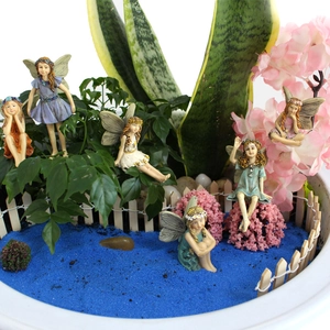 Detail of 6 resin flower fairy figurines in a miniature garden landscape scene