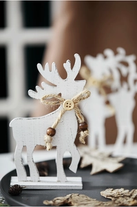 Close-up of white wooden reindeer decor with burlap bow, wooden button and bead details