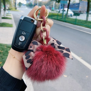Fashionable red fox fur pom pom keychain with leopard bow tie and gold metal chain
