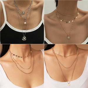 Detail showing layered gold and silver chains with floral and pearl pendants for women