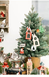 Close-up of hand-painted wooden Christmas house pendants and Nordic holiday ornaments