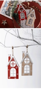 Detail of red and white wooden house ornaments hanging with rustic snowflake patterns