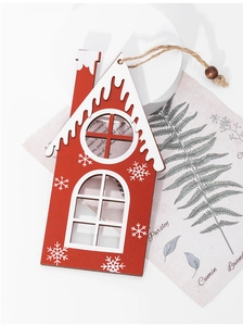 Detail of red wooden house ornament with white snowflakes and jute rope for Christmas