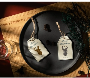 Detail of reindeer Merry Christmas tags with gold glitter and rustic jute twine