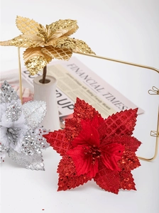 Detailed view of glitter artificial Christmas flowers in gold, silver and red finish