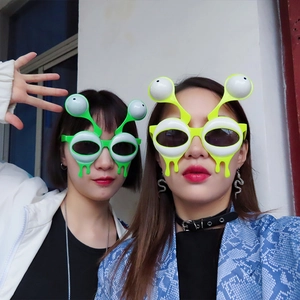 Funny alien eyeball party glasses in neon green and yellow for costumes and raves