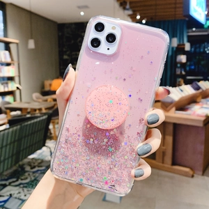 Close-up of pink glitter phone case with a matching star-patterned pop socket grip