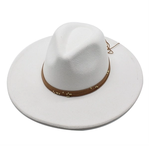 Detail of white wide brim wool fedora with brown beaded rope trim and gold accents