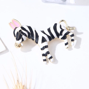 Handcrafted enamel zebra brooch with black and white stripes and gold-tone metal edges