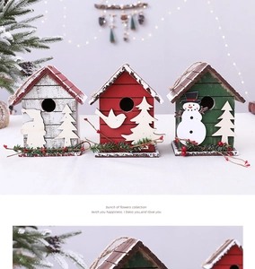 Detail view of festive wooden birdhouses with snow texture, Santas, and pine branch accents