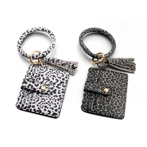 Detail view of leopard print PU leather card holder wristlet with tassel and key ring