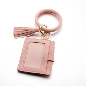 Pink PU leather card holder with scalloped edges, wristlet ring, and dual-tone tassel detail
