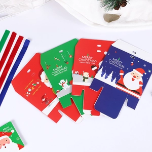 Flat lay of colorful Christmas gift boxes with reindeer and Santa designs on white background