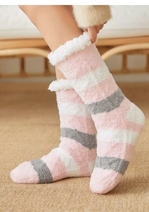 Close-up of pink and grey striped plush coral fleece floor socks with soft white trim