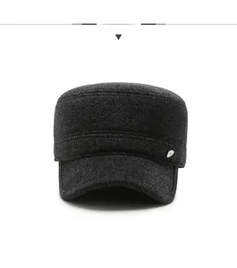 Close-up of dark grey wool cap with twill texture and R SPORT metal badge detail