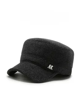 Detailed close-up of dark grey wool fabric with metallic R sport logo on a men's winter cap