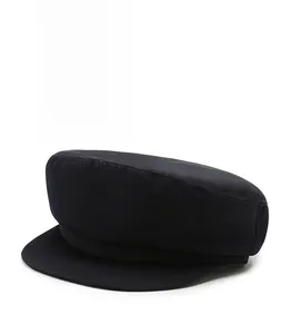 Detail of navy cotton flat cap showing twill fabric texture and classic stiffened brim
