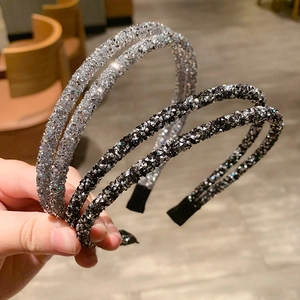 Detail of silver and black thin crystal headbands with sparkling rhinestones and soft tips
