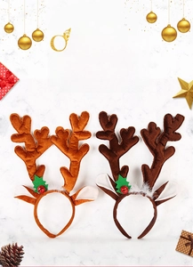 Detail of Christmas reindeer antler headband with festive bells and holly leaf decoration