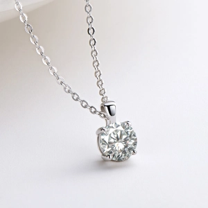 Macro detail of 1 carat moissanite pendant with classic four-prong silver setting