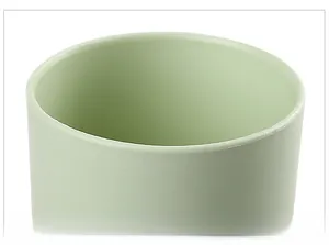 Macro view of the smooth rounded rim and matte mint green texture of this travel cup