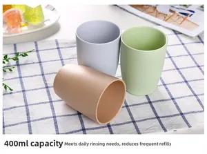 Three minimalist 400ml matte travel cups in beige, grey, and green on a checkered cloth