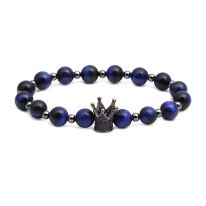 Detailed close-up of blue tiger eye beads and micro-pave crown charm on men's bracelet